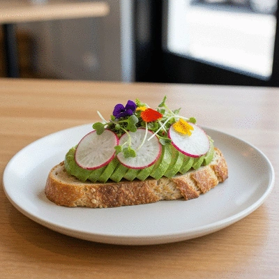 Gourmet vegan avocado toast with edible flowers and seeds in a Fitzroy cafe